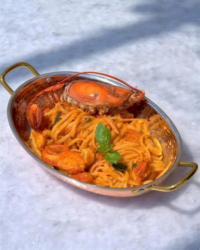 Lobster linguine in a copper pan