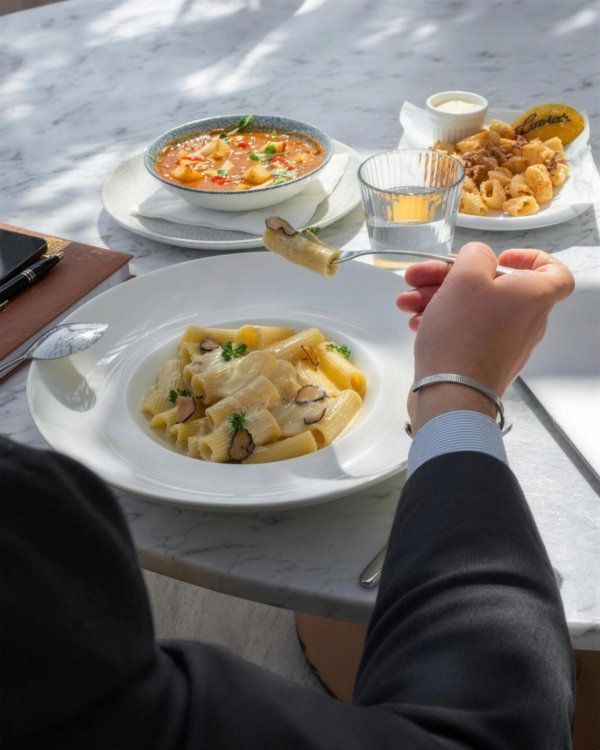 Guests sharing pasta and fritto at Lucia's